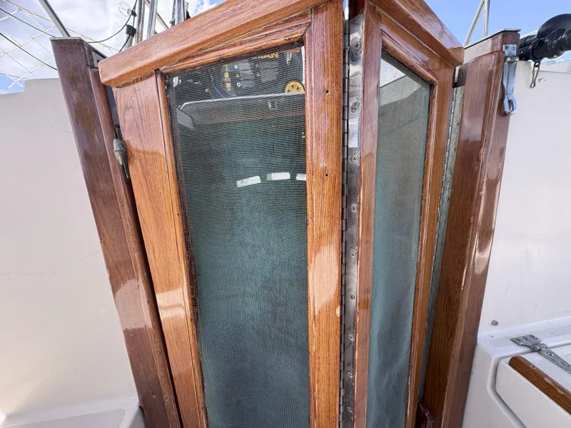 Slide: The Image of Wooden hatch door on a 1979 CSY 44 sailboat, featuring a mesh screen. - 31