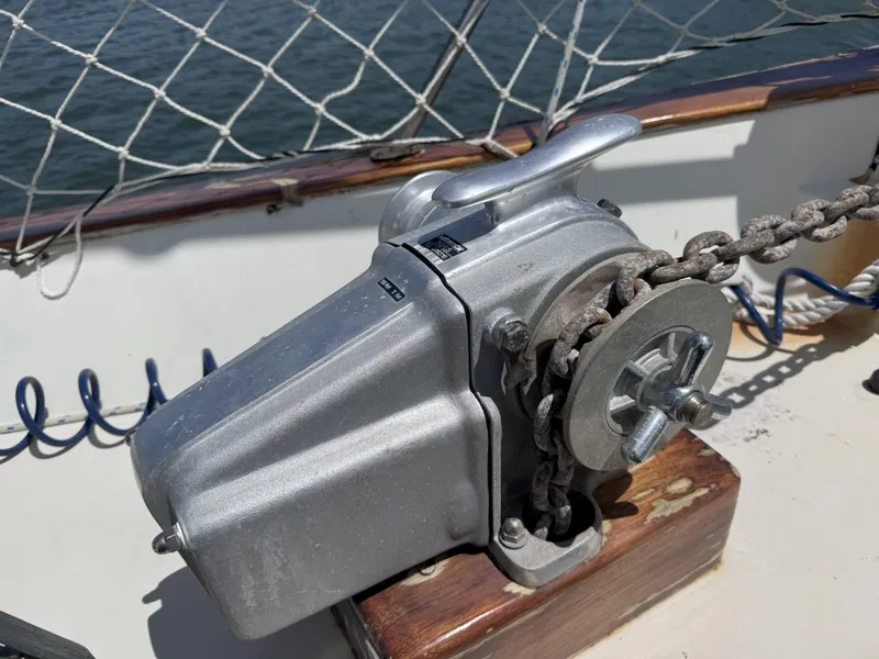 Slide: The Image of Anchor windlass on a 1979 CSY 44 sailboat deck, with chain and netting. - 36