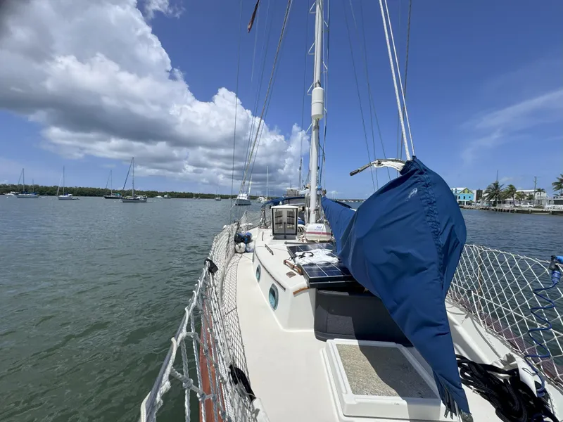 Slide: The Image of Sailboat CSY 44 from 1979 on calm waters under a blue sky. - 4