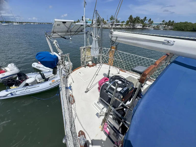 Slide: The Image of Sailboat deck with equipment, docked near shore, featuring a 1979 CSY 44 model. - 6
