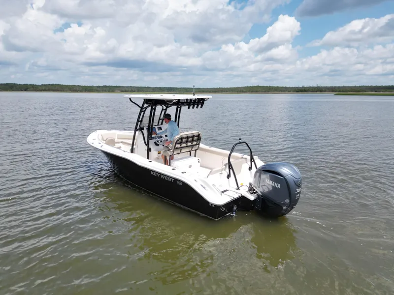 Slide: The Image of 2024 Key West 239 FS boat on calm water under a cloudy sky. - 3