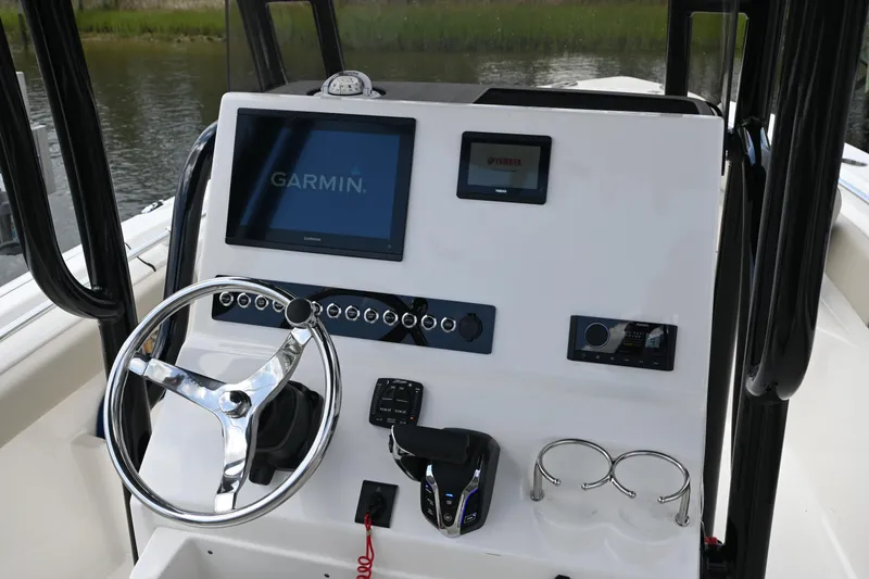 Slide: The Image of 2024 Key West 239 FS boat dashboard with Garmin display and steering wheel. - 4