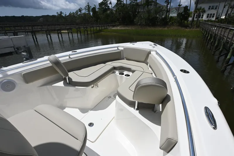 Slide: The Image of 2024 Key West 239 FS boat interior with cushioned seating and cup holders. - 5