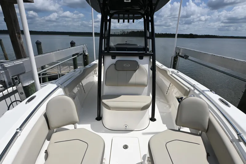 Slide: The Image of 2024 Key West 239 FS boat interior with seating, docked by a serene lake. - 7