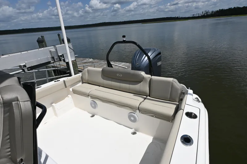 Slide: The Image of 2024 Key West 239 FS boat with seating, docked by calm waters under a cloudy sky. - 9