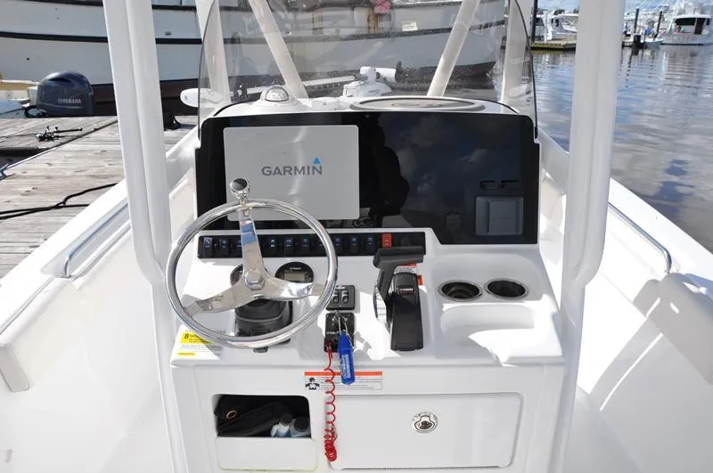 Slide: The Image of 2020 Sea Hunt Ultra 225 boat console with Garmin navigation system and steering wheel. - 15
