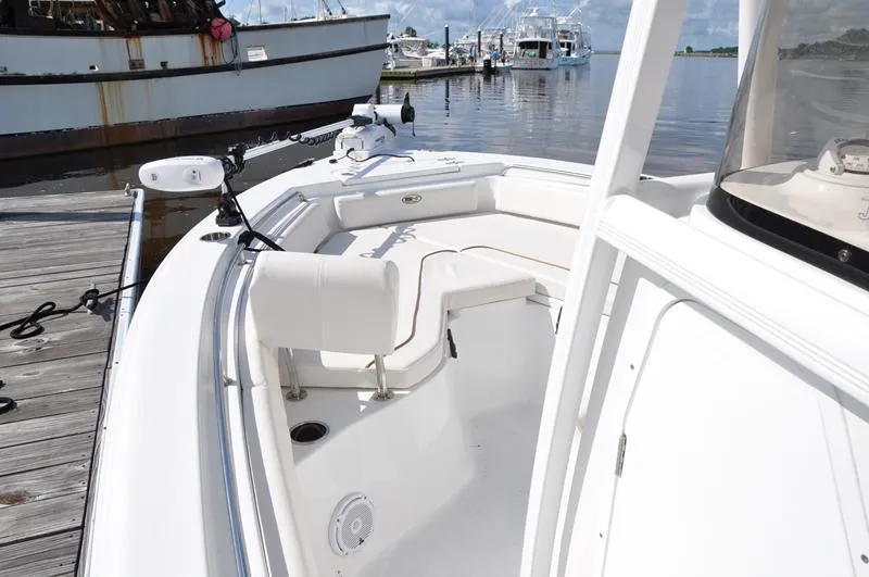 Slide: The Image of 2020 Sea Hunt Ultra 225 boat docked, featuring spacious seating and sleek design. - 18