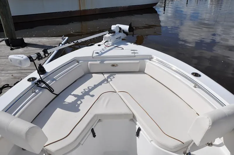 Slide: The Image of 2020 Sea Hunt Ultra 225 boat with cushioned seating and trolling motor. - 19