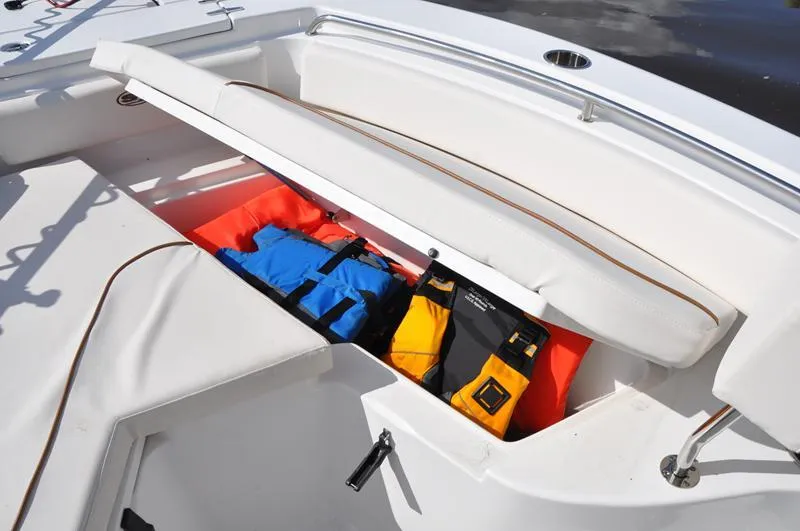 Slide: The Image of Storage compartment on 2020 Sea Hunt Ultra 225 boat with life jackets. - 23