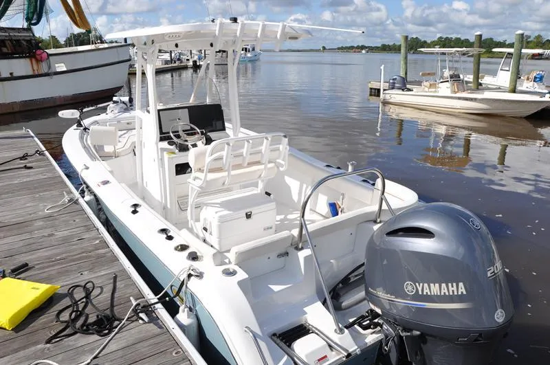 Slide: The Image of 2020 Sea Hunt Ultra 225 boat docked with Yamaha engine, under clear skies. - 3