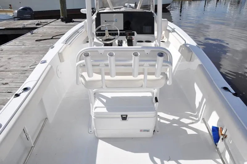 Slide: The Image of 2020 Sea Hunt Ultra 225 boat interior with helm and rod holders. - 4