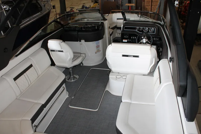 Slide: The Image of 2018 Sea Ray 280 SLX boat interior with white seating and modern dashboard. - 10