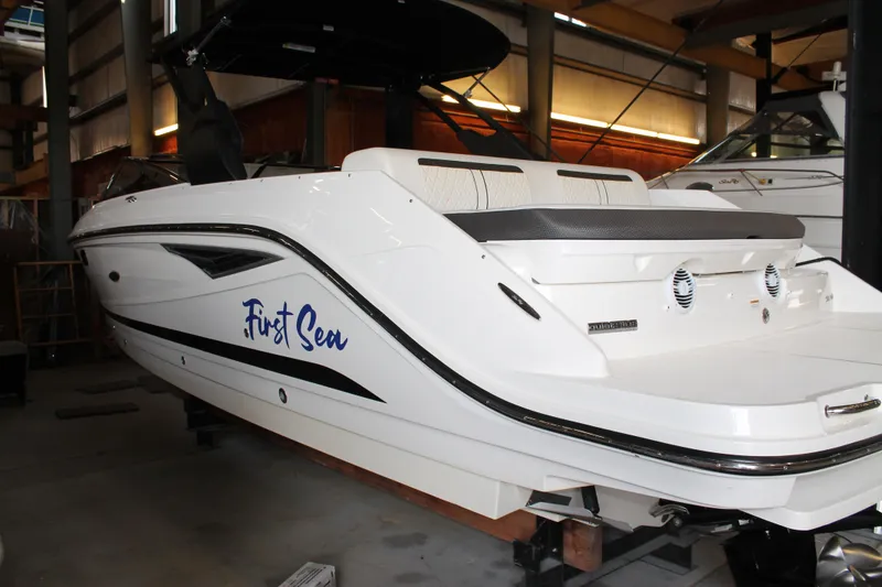 Slide: The Image of 2018 Sea Ray 280 SLX boat named "First Sea" in a storage facility. - 2