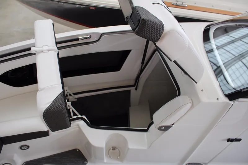 Slide: The Image of 2018 Sea Ray 280 SLX boat interior with white seating and storage compartment. - 23