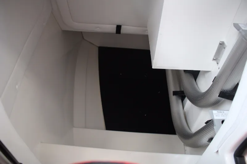 Slide: The Image of Interior compartment of 2018 Sea Ray 280 SLX boat, featuring storage space and tubing. - 24