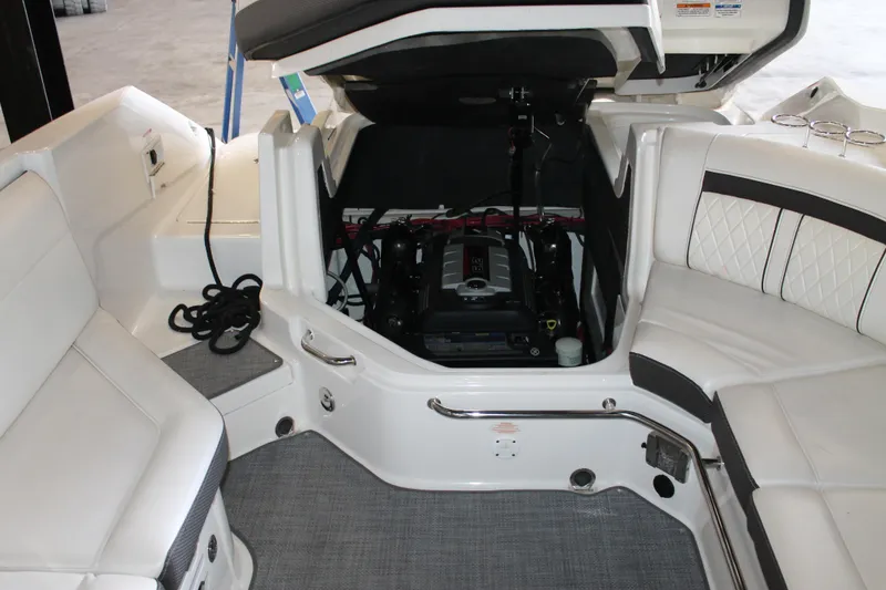 Slide: The Image of 2018 Sea Ray 280 SLX boat interior with open engine compartment and seating area. - 27