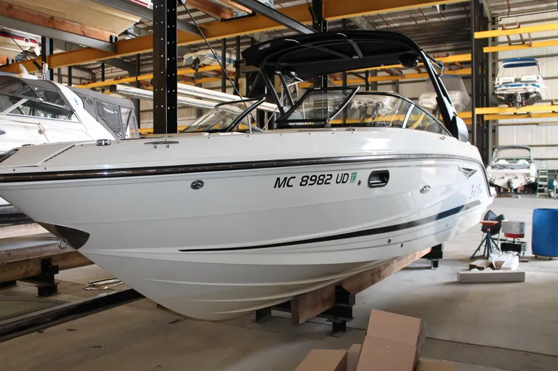 Slide: The Image of 2018 Sea Ray 280 SLX boat in storage, showcasing sleek design and modern features. - 6