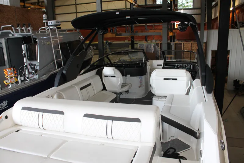 Slide: The Image of 2018 Sea Ray 280 SLX boat interior with white seating in a storage facility. - 8