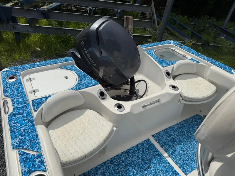 Slide: The Image of 2013 Sea Fox 199 Commander boat interior with Yamaha engine and blue patterned flooring. - 10