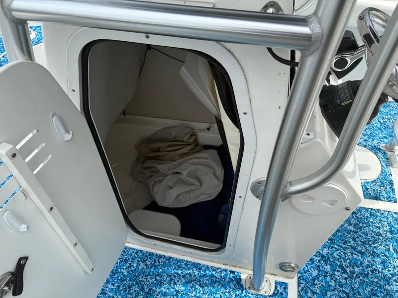Slide: The Image of 2013 Sea Fox 199 Commander boat storage compartment with open door and visible interior. - 13