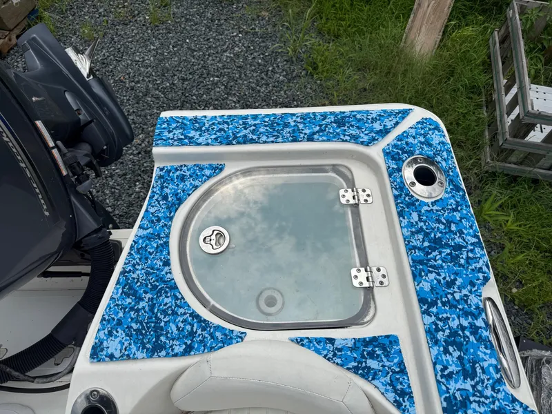 Slide: The Image of 2013 Sea Fox 199 Commander boat with blue camo deck and livewell. - 15