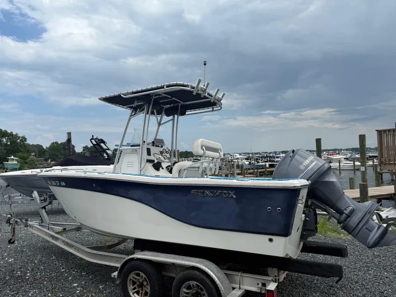 Slide: The Image of 2013 Sea Fox 199 Commander boat on trailer at marina, cloudy sky background. - 5