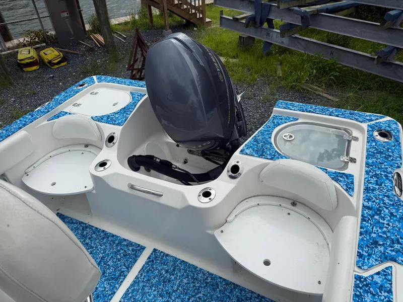 Slide: The Image of 2013 Sea Fox 199 Commander boat with blue deck, outboard motor, and storage compartments. - 9