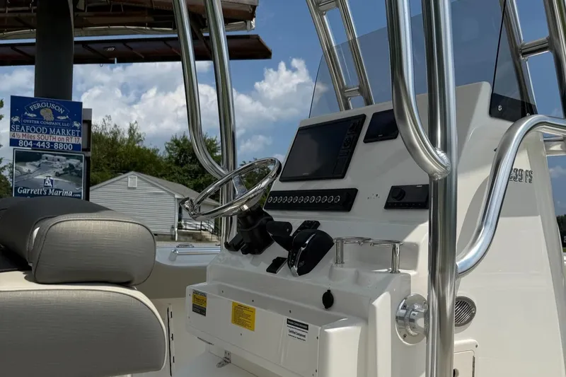 Slide: The Image of 2025 Key West 239 FS boat console with steering wheel and controls. - 2