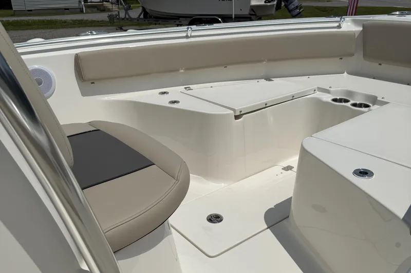 Slide: The Image of 2025 Key West 239 FS boat interior with beige seating and cup holders. - 4