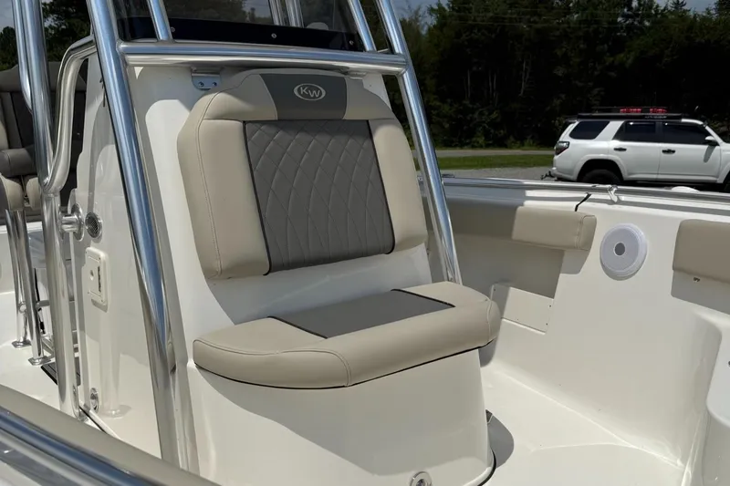 Slide: The Image of 2025 Key West 239 FS boat interior with cushioned seating and stainless steel details. - 5