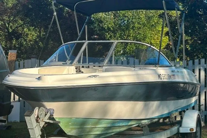 Slide: The Image of 2002 Bayliner 184 SF boat on trailer with canopy, parked outdoors. - 10