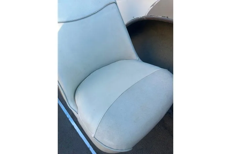 Slide: The Image of White seat of a 2002 Bayliner 184 SF boat, showing slight wear. - 12