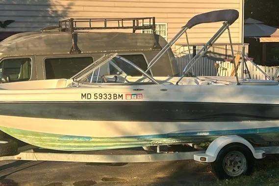 Slide: The Image of 2002 Bayliner 184 SF boat on trailer, parked beside a van. - 9