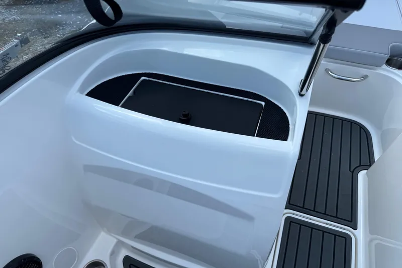 Slide: The Image of 2025 Bayliner VR4 Bowrider OB interior detail with storage compartment and sleek design. - 11