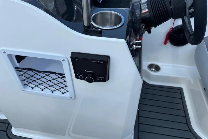 Slide: The Image of 2025 Bayliner VR4 Bowrider OB dashboard with cup holder and control panel. - 14