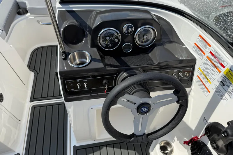 Slide: The Image of 2025 Bayliner VR4 Bowrider OB dashboard with steering wheel and control panel. - 15