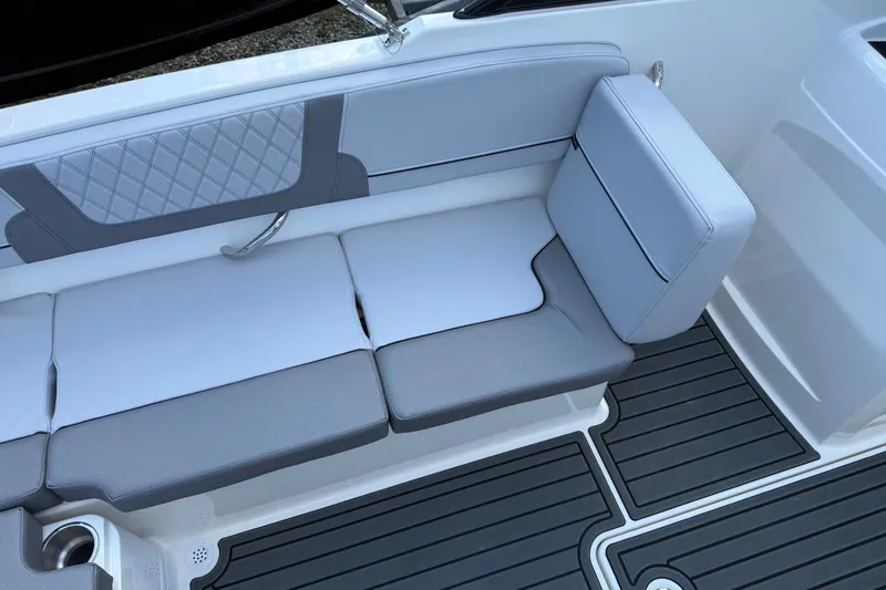 Slide: The Image of 2025 Bayliner VR4 Bowrider OB interior seating with gray cushions and sleek design. - 9
