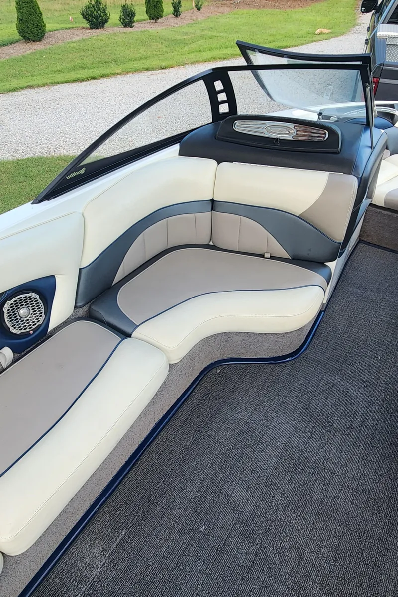 Slide: The Image of 2013 Malibu Wakesetter 23 LSV interior with white and gray seating, open windshield. - 10