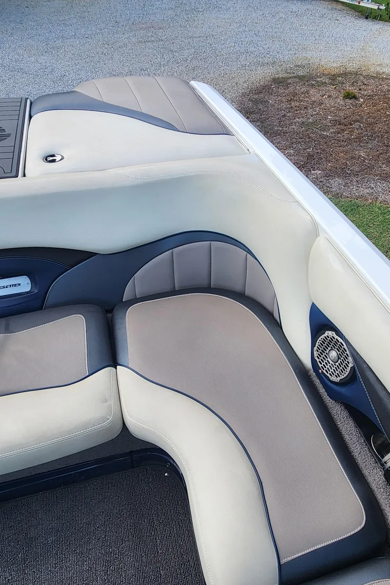 Slide: The Image of 2013 Malibu Wakesetter 23 LSV interior with gray and blue cushioned seating. - 11
