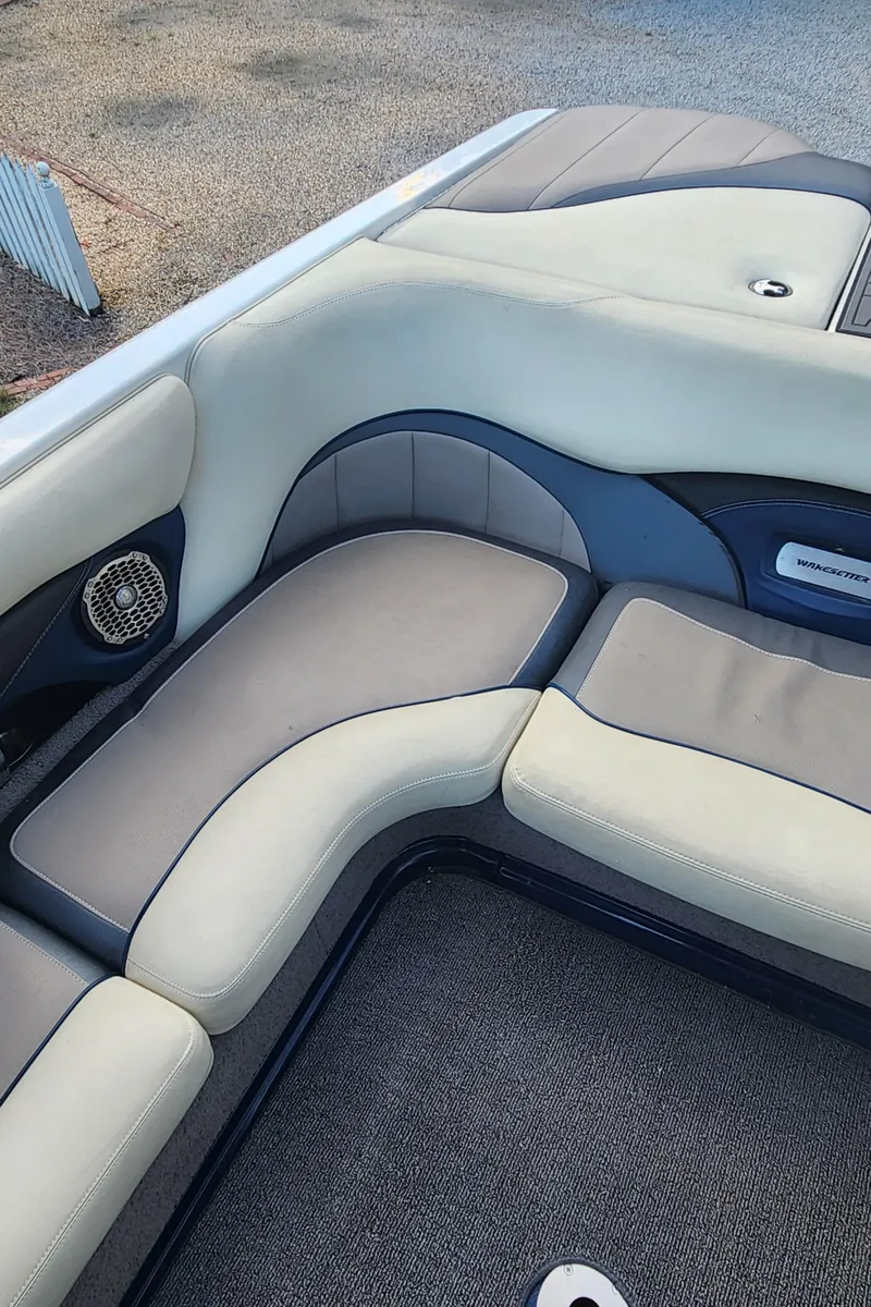 Slide: The Image of 2013 Malibu Wakesetter 23 LSV interior seating with beige and gray upholstery. - 13