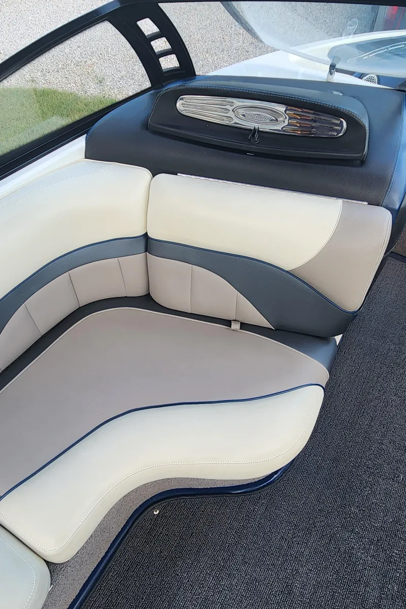 Slide: The Image of 2013 Malibu Wakesetter 23 LSV interior seating with beige and gray upholstery. - 14