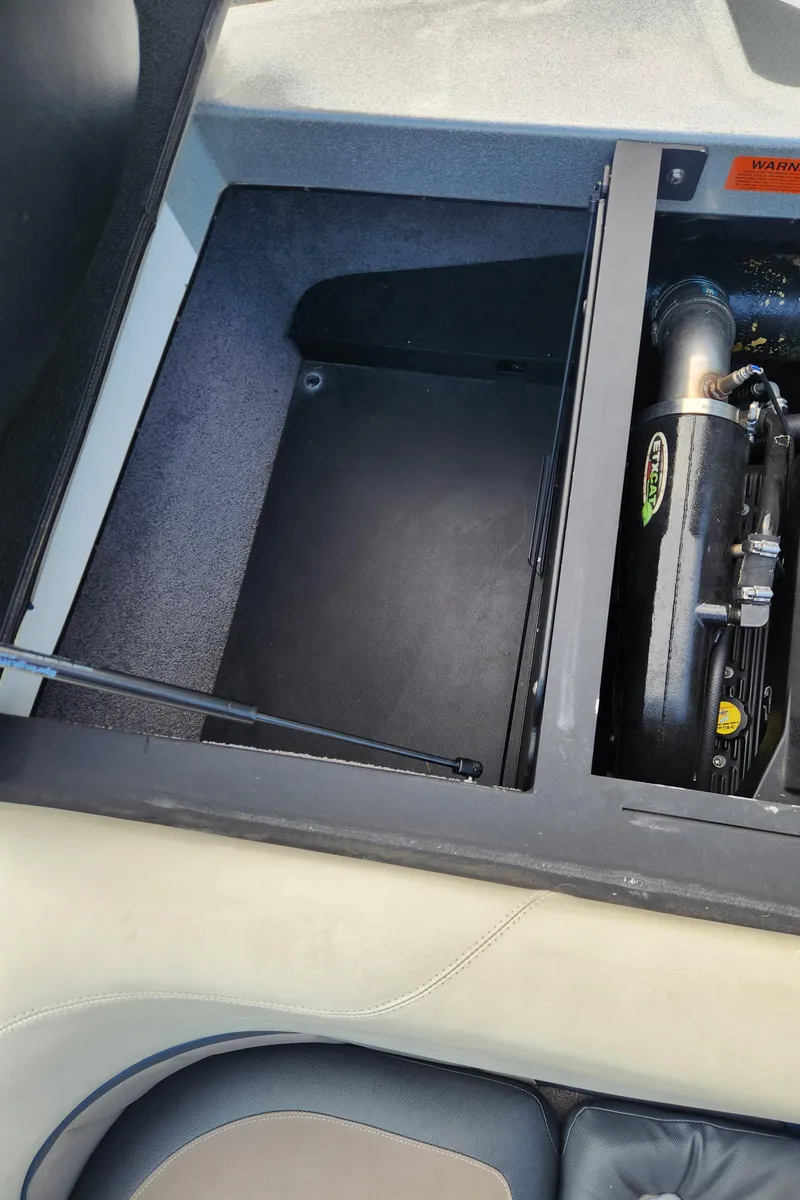 Slide: The Image of Engine compartment of a 2013 Malibu Wakesetter 23 LSV boat, showcasing interior details. - 15