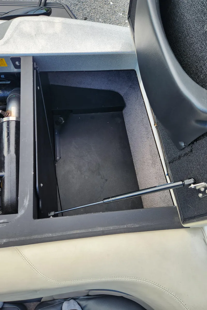 Slide: The Image of Open storage compartment in 2013 Malibu Wakesetter 23 LSV boat. - 16