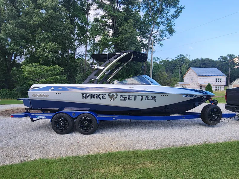 Slide: The Image of 2013 Malibu Wakesetter 23 LSV boat on trailer, parked outdoors. - 5