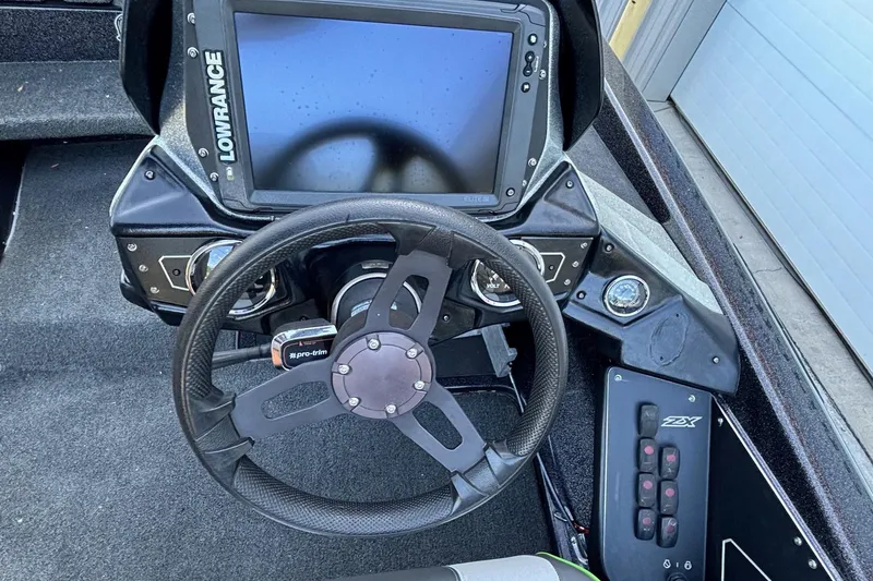 Slide: The Image of 2018 Skeeter ZX225 boat dashboard with Lowrance display and steering wheel. - 10