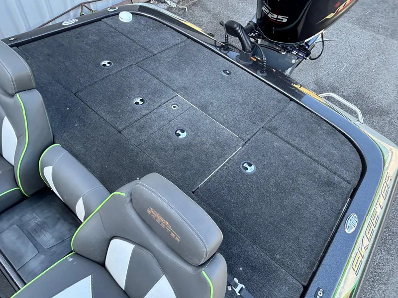 Slide: The Image of 2018 Skeeter ZX225 boat interior with cushioned seats and carpeted deck. - 11