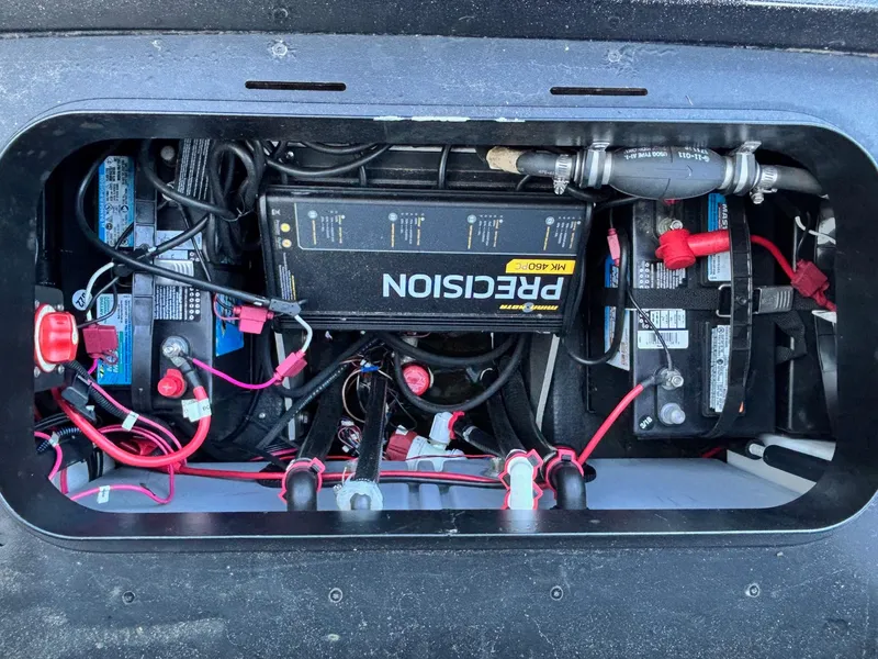 Slide: The Image of 2018 Skeeter ZX225 battery compartment with wiring and charger setup. - 12