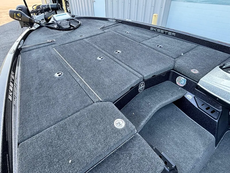 Slide: The Image of 2018 Skeeter ZX225 boat deck with storage compartments and fishing equipment. - 5