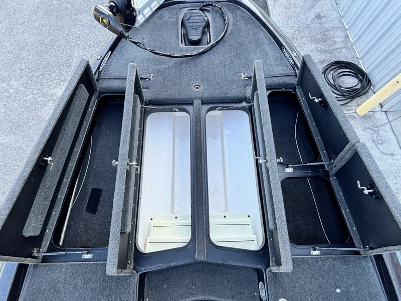 Slide: The Image of 2018 Skeeter ZX225 boat storage compartments open, showcasing interior layout. - 6