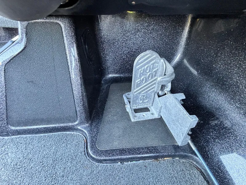 Slide: The Image of 2018 Skeeter ZX225 boat foot throttle pedal, labeled "Hot Foot," on textured flooring. - 9